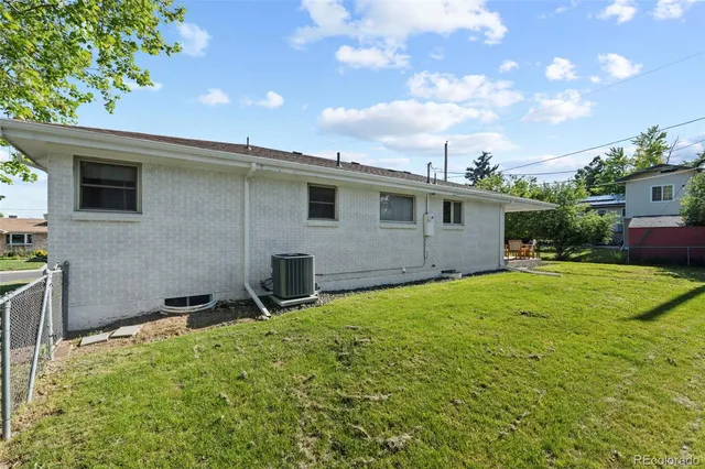 a backyard of a house with table and chairs