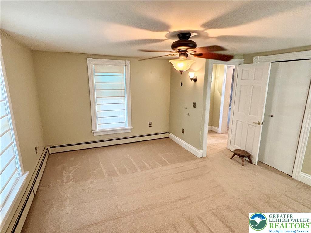 7241 Decatur Street New Tripoli, PA 18066 - Photo 22 of 36 A comfortable bedroom features carpet flooring and a practical ceiling fan with illumination.