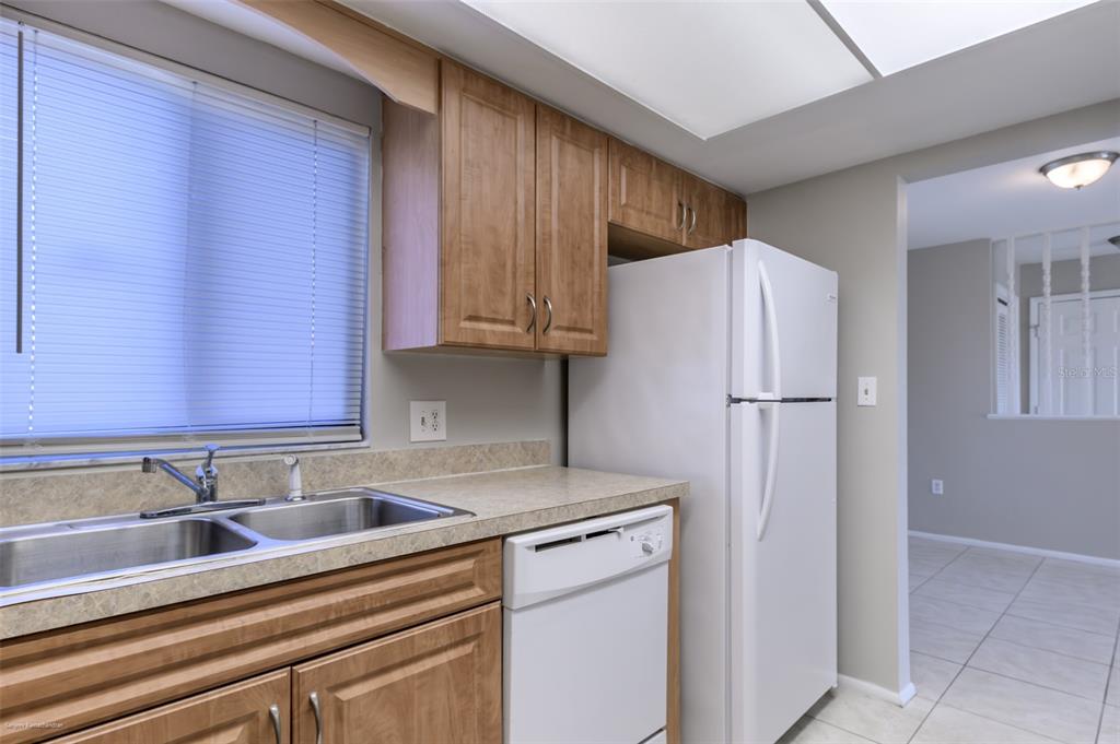 1204 Spanish Cay Lane, Unit B Punta Gorda, FL 33950 - Photo 22 of 45 a kitchen with stainless steel appliances granite countertop a refrigerator sink and cabinets