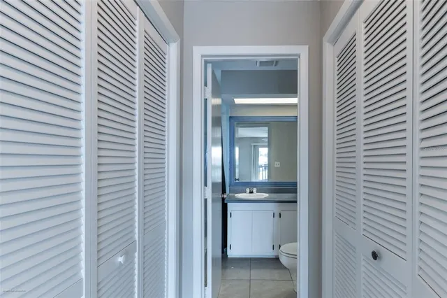 a bathroom with a granite countertop sink a toilet and a mirror