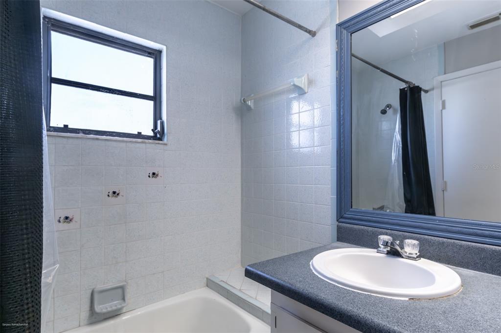 1204 Spanish Cay Lane, Unit B Punta Gorda, FL 33950 - Photo 39 of 45 a bathroom with a sink and a mirror