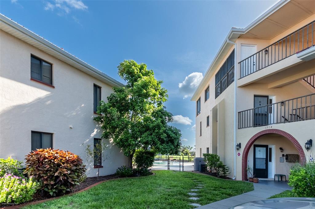 1204 Spanish Cay Lane, Unit B Punta Gorda, FL 33950 - Photo 41 of 45 a front view of a house with garden