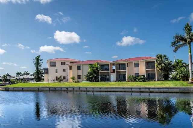 a front view of a house with a lake view and sitting area
