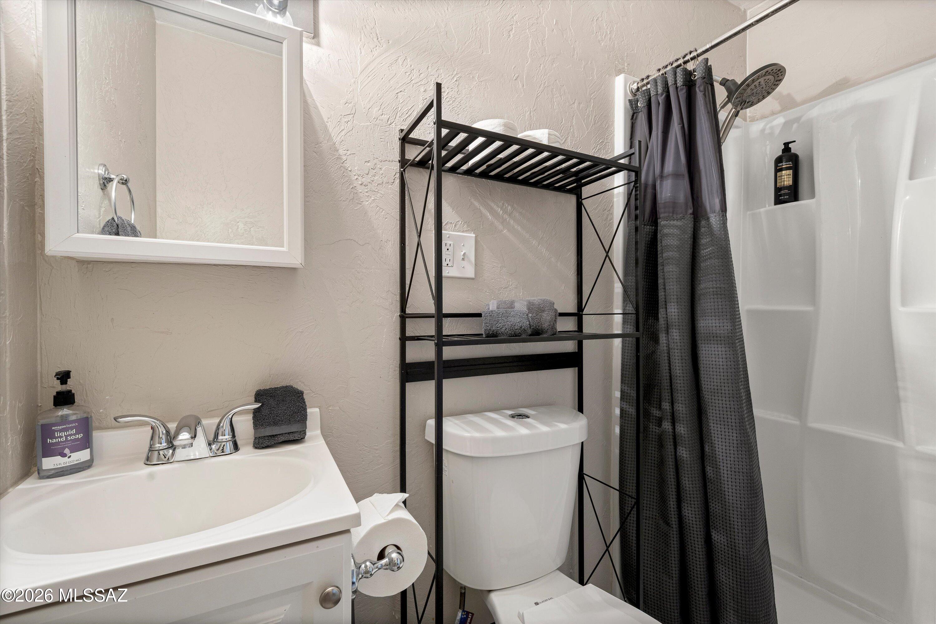 2841 North Richey Boulevard Tucson, AZ 85716 - Photo 30 of 30 a bathroom with a sink a toilet and a mirror