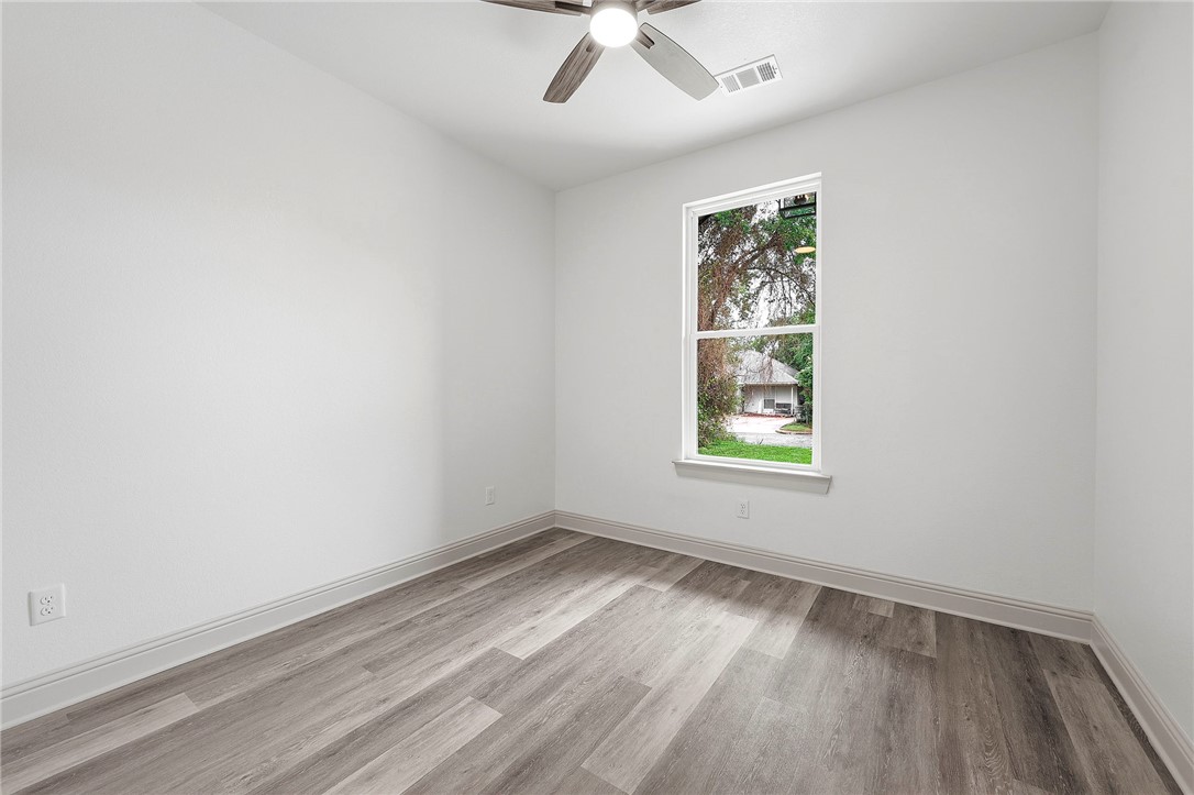 505 Legion Court Bryan, TX 77803 - Photo 16 of 21 an empty room with a window and wooden floor