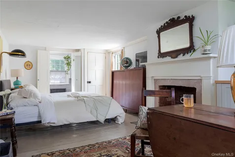 a bedroom with a bed and painting on the wall
