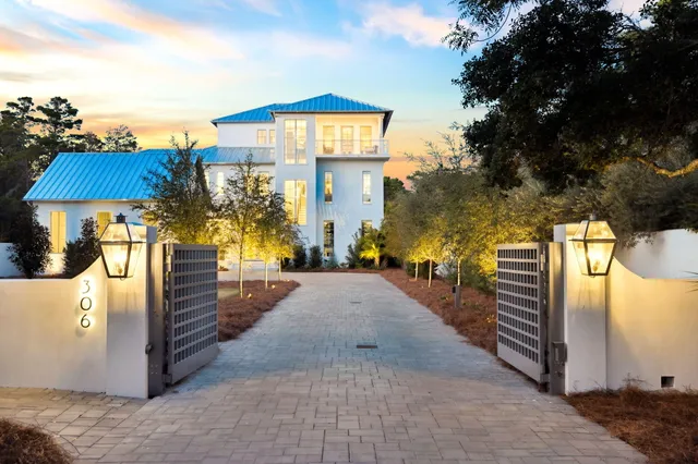 a view of a balcony with wooden floor next to a yard