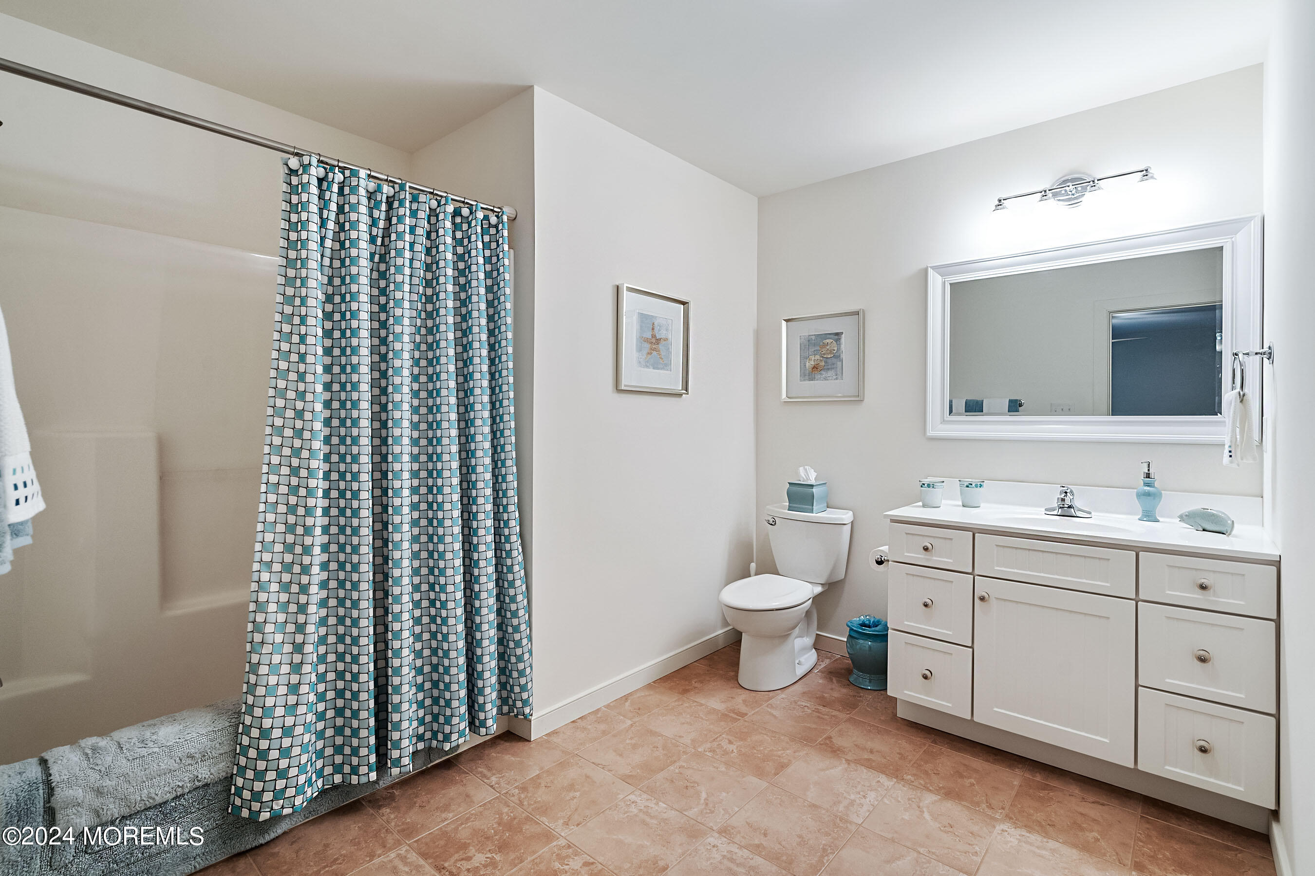 556 Riverside Drive Manasquan, NJ 08736 - Photo 11 of 42 a bathroom with a toilet a sink and mirror