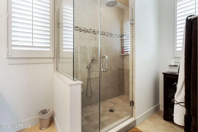 a bathroom with a shower and a sink