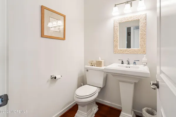 a bathroom with a sink mirror and toilet