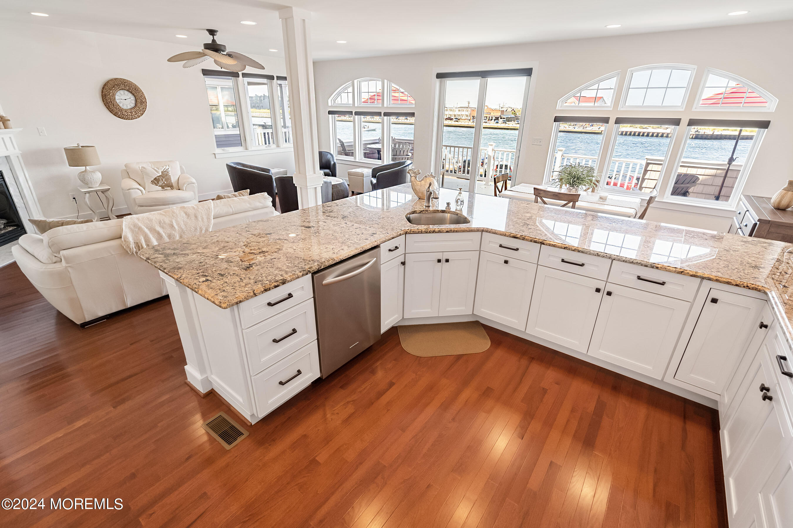 556 Riverside Drive Manasquan, NJ 08736 - Photo 18 of 42 a spacious kitchen with stainless steel appliances granite countertop a sink dishwasher and white cabinets with wooden floor