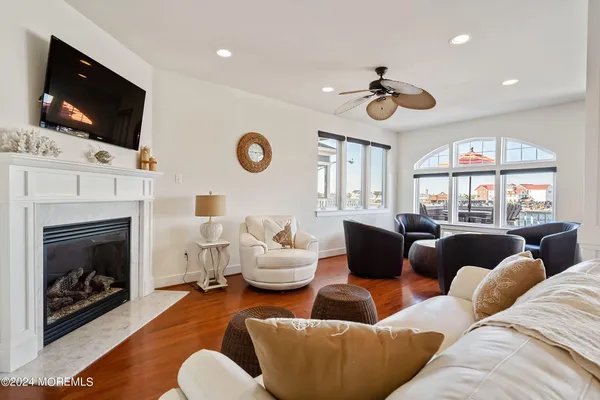 a living room with furniture a fireplace and a flat screen tv