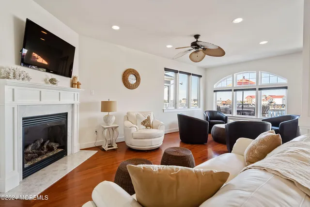 a living room with furniture a fireplace and a flat screen tv