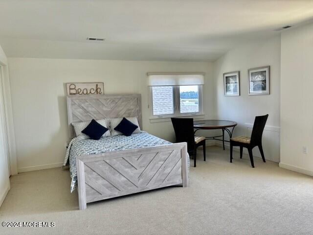 556 Riverside Drive Manasquan, NJ 08736 - Photo 29 of 42 a bedroom with a bed and a table in it