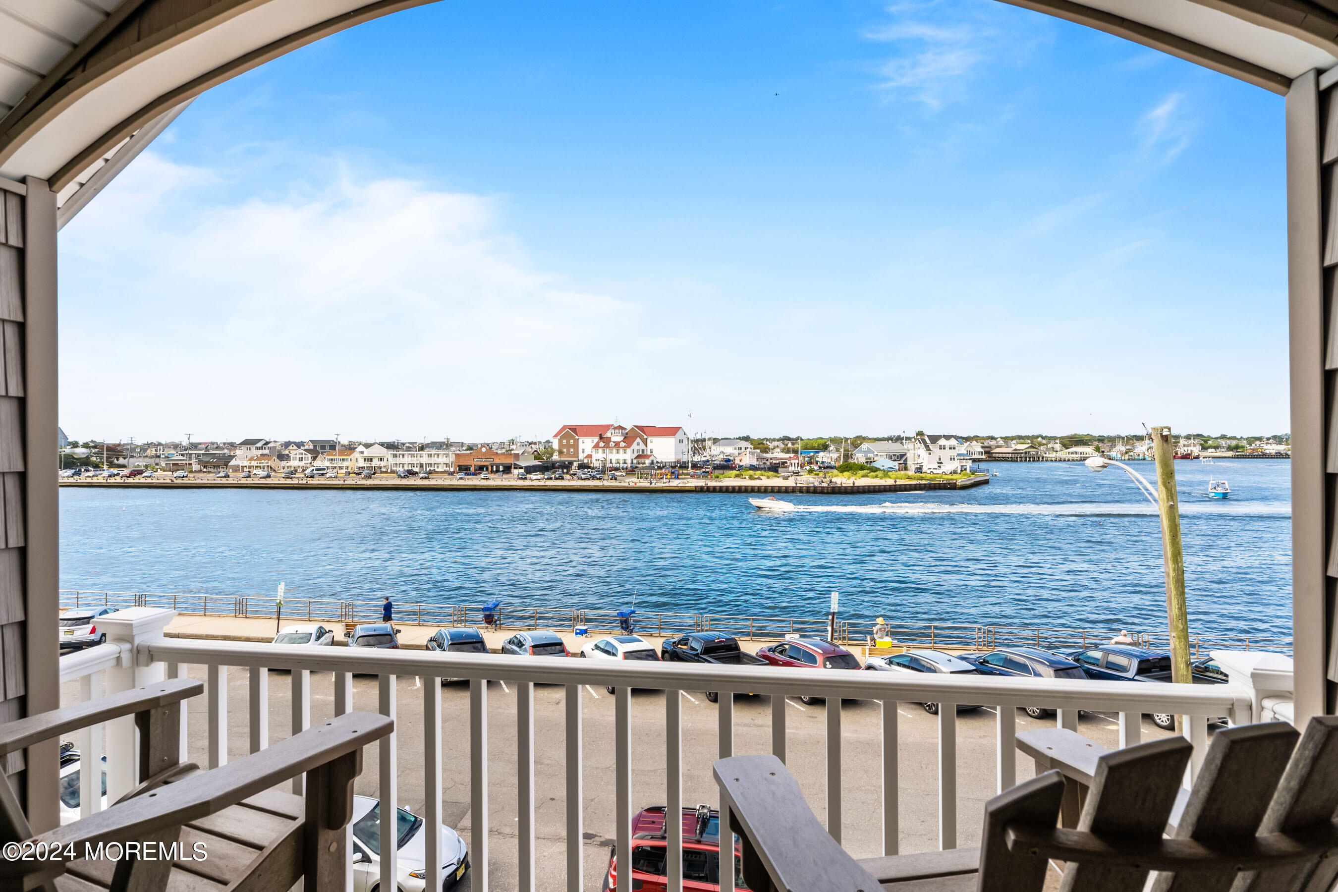 556 Riverside Drive Manasquan, NJ 08736 - Photo 33 of 42 a view of a balcony with wooden chairs and city view