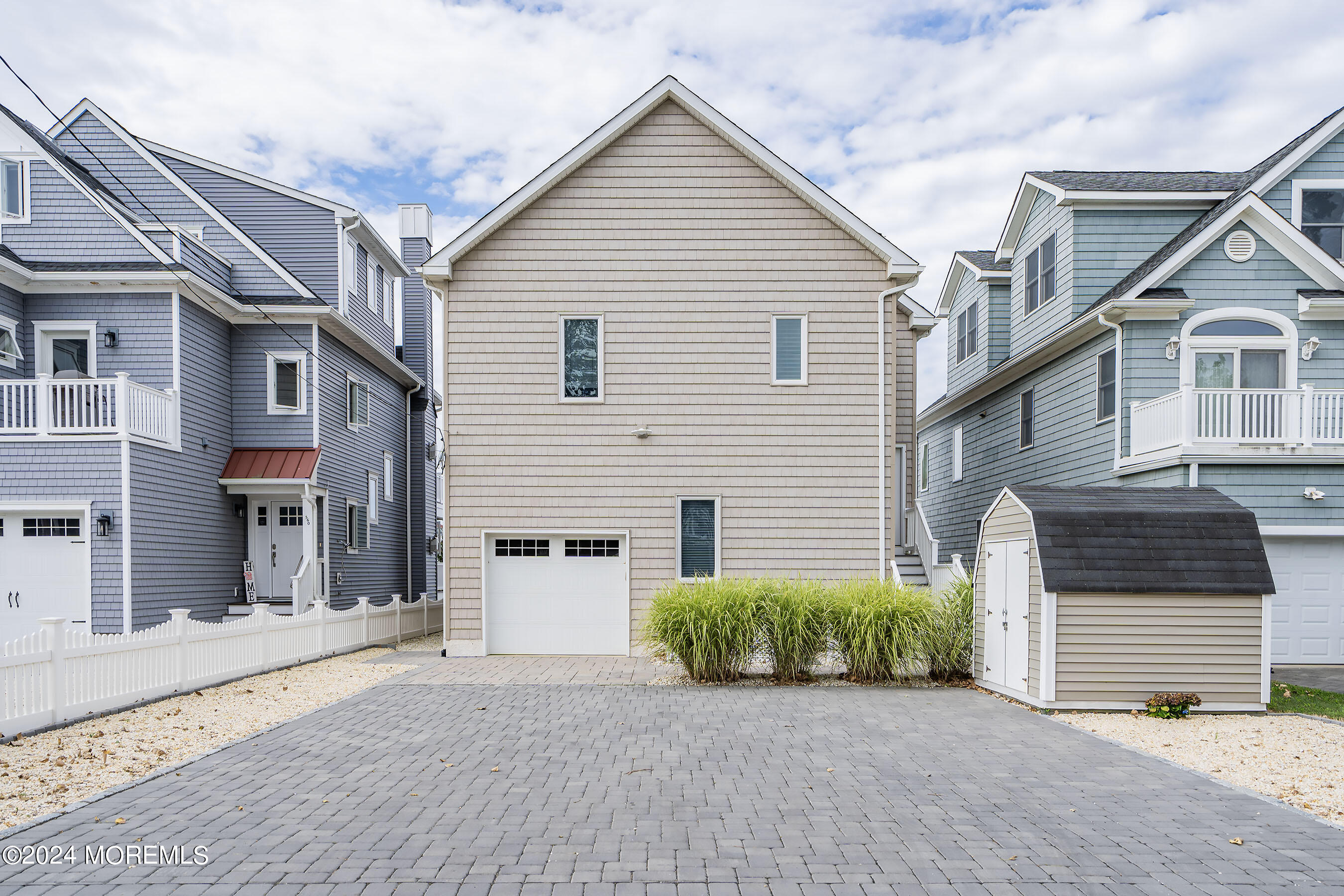 556 Riverside Drive Manasquan, NJ 08736 - Photo 38 of 42 a view of a house with a yard and garage