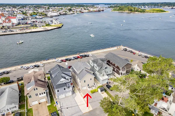 an aerial view of a house with a lake