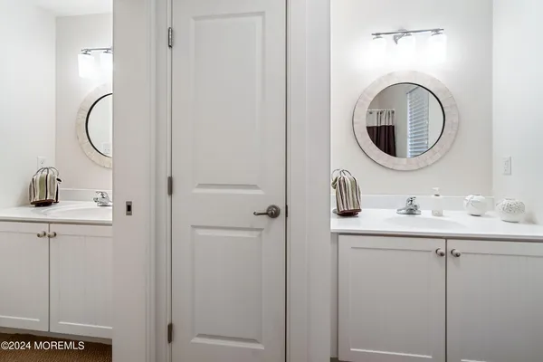 a bathroom with a granite countertop toilet sink and mirror