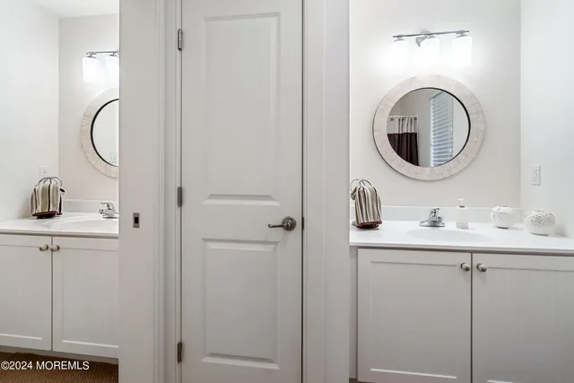 a bathroom with a granite countertop toilet sink and mirror