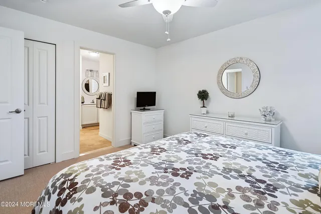 a bedroom with a bed and a mirror