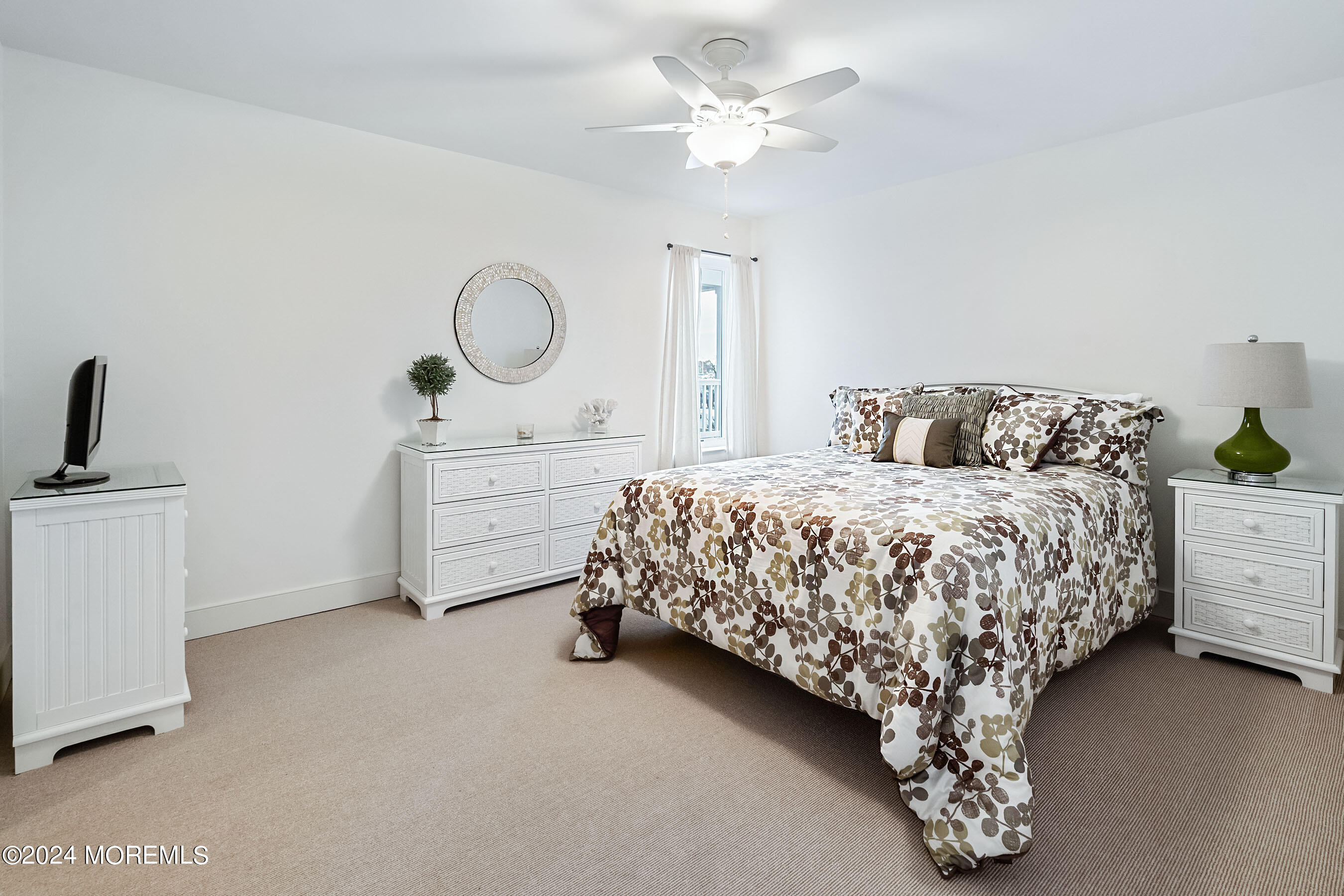 556 Riverside Drive Manasquan, NJ 08736 - Photo 8 of 42 a bedroom with a bed and a chandelier