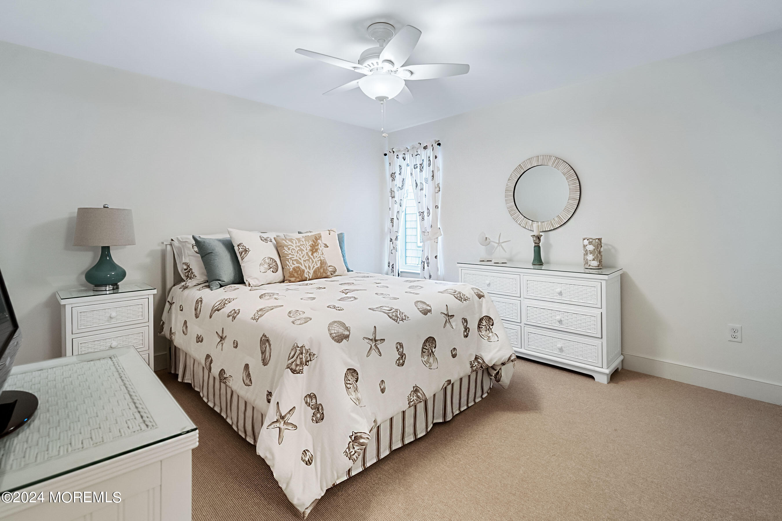 556 Riverside Drive Manasquan, NJ 08736 - Photo 9 of 42 a bedroom with a bed and a chandelier