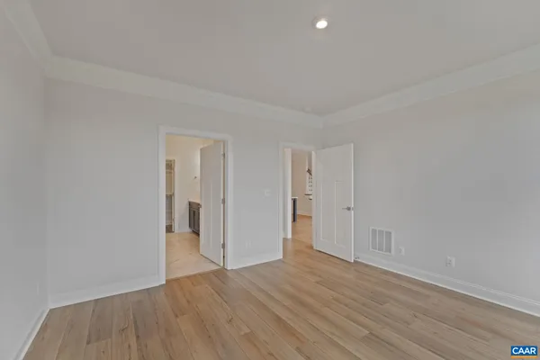 a view of an empty room and wooden floor