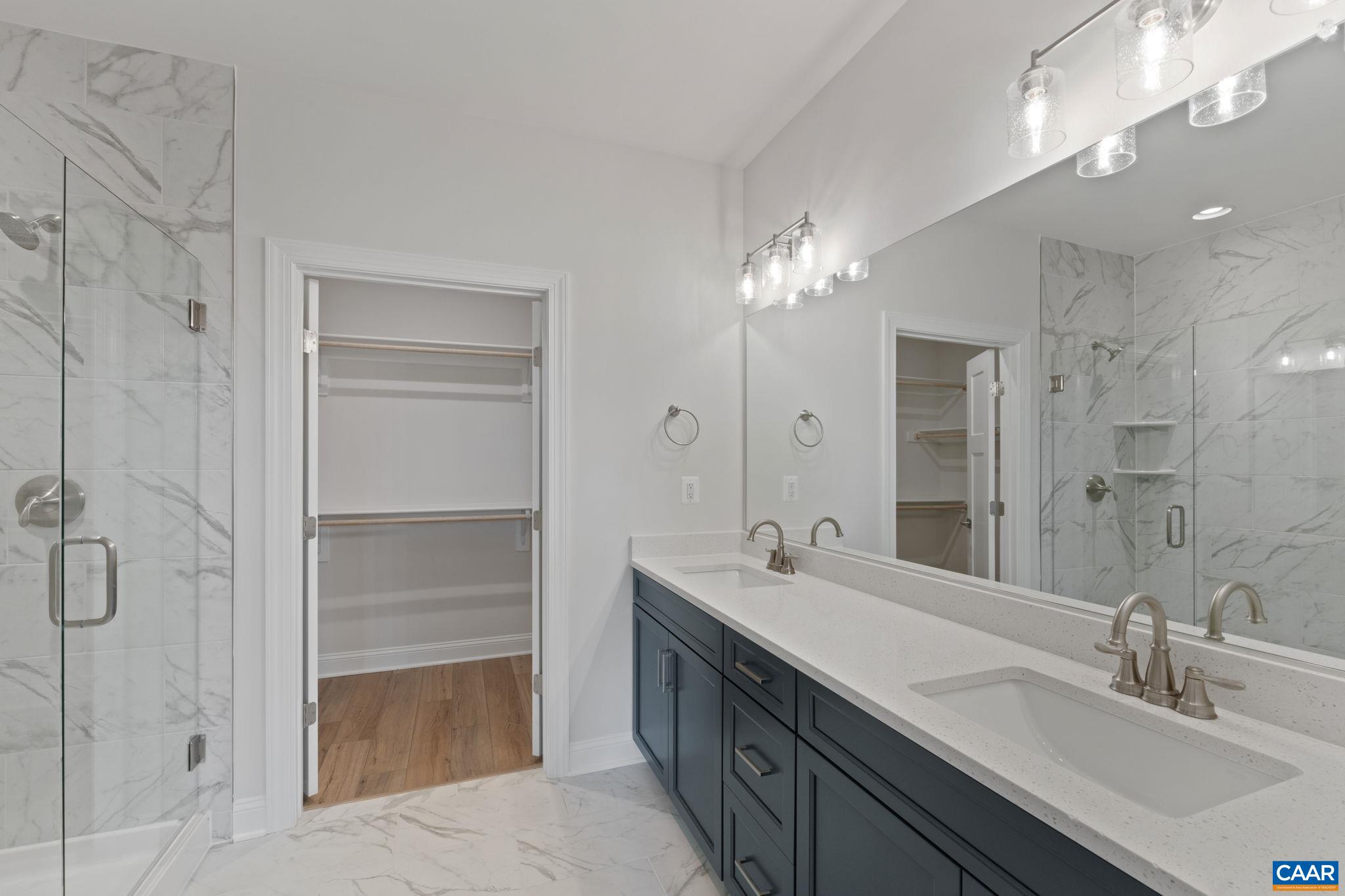 135 Springdale Road Waynesboro, VA 22980 - Photo 17 of 37 a bathroom with a double vanity sink a mirror and a shower
