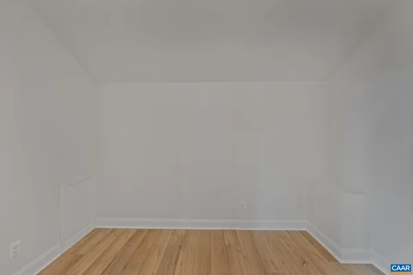 a view of a room with wooden floor