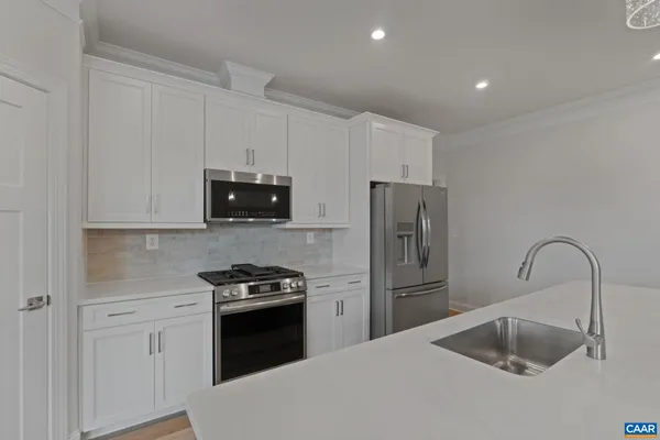 a kitchen with a refrigerator sink and microwave