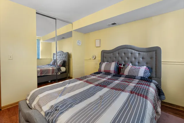 a bedroom with a bed and a mirror