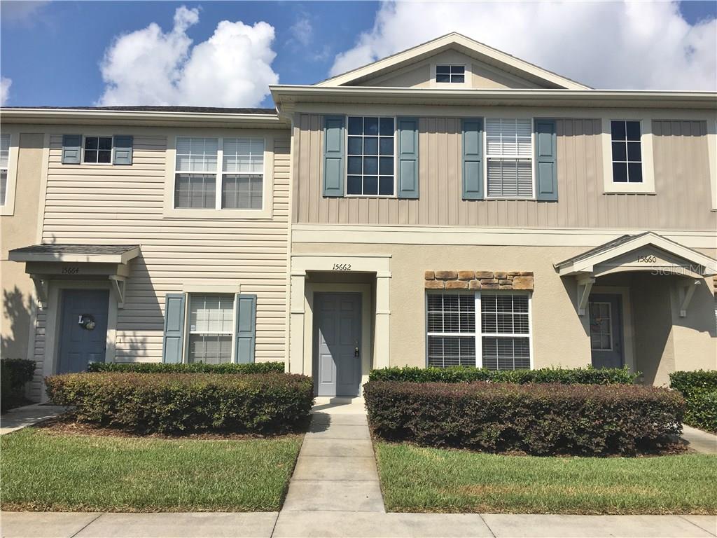 15662 Stable Run Drive Spring Hill, FL 34610 - Photo 1 of 1 a front view of a house with a yard