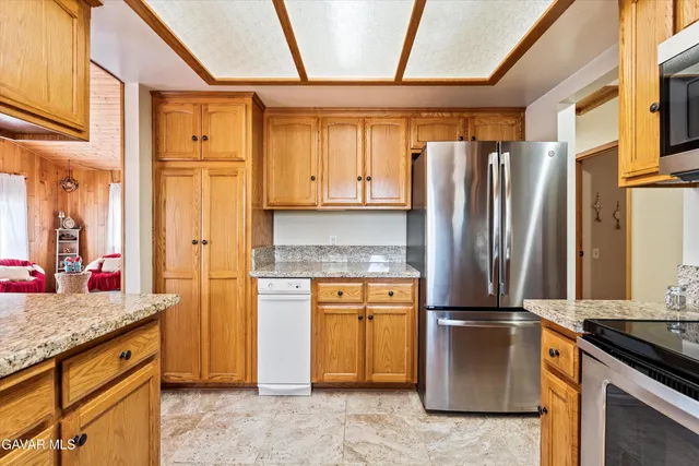 a bathroom with a granite countertop sink toilet and mirror