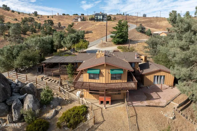 an aerial view of a house with a yard and lake view
