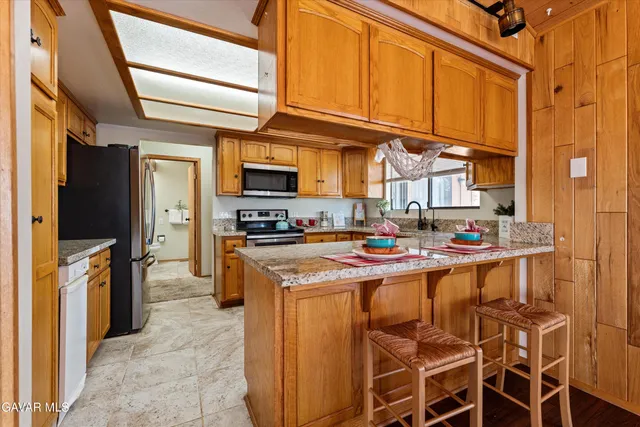 a kitchen with stainless steel appliances granite countertop a refrigerator and a stove
