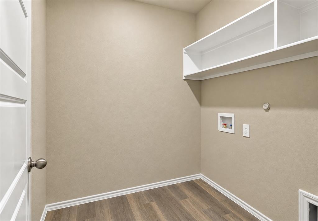 15932 Stableford Road Justin, TX 76247 - Photo 24 of 35 Laundry area featuring wood-finish flooring, built-in shelving, and utility hookups