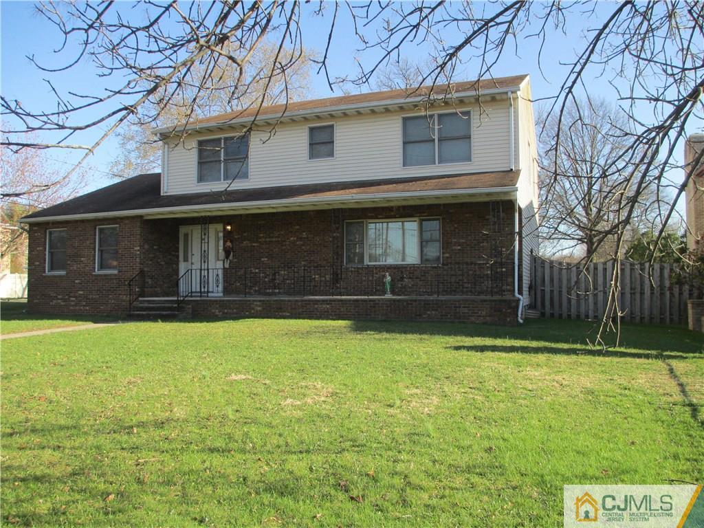 907 New Dover Road Edison, NJ 08820 - Photo 1 of 21 a front view of a house with a yard