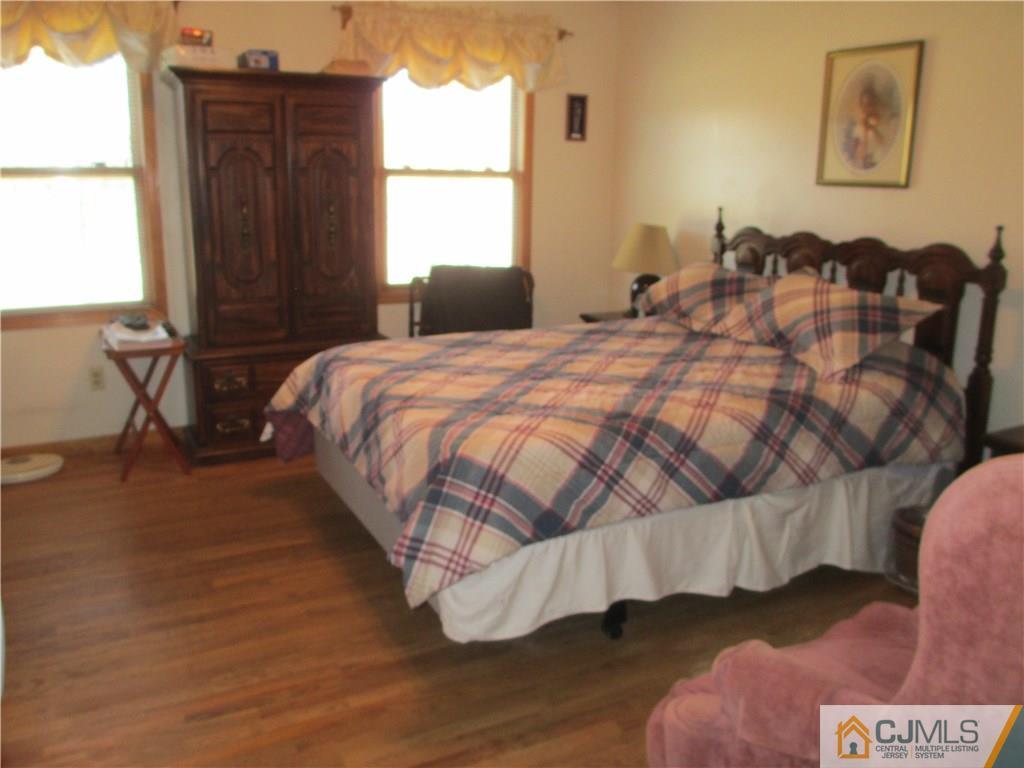 907 New Dover Road Edison, NJ 08820 - Photo 12 of 21 a bedroom with a bed and a window