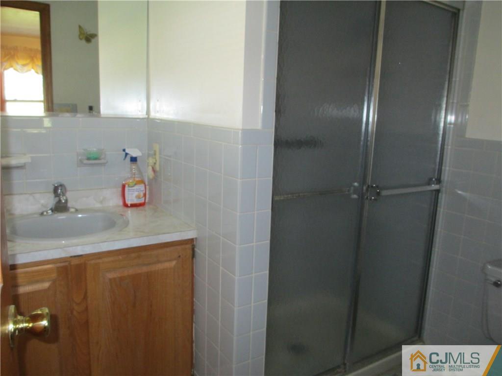 907 New Dover Road Edison, NJ 08820 - Photo 13 of 21 a bathroom with a sink and a shower