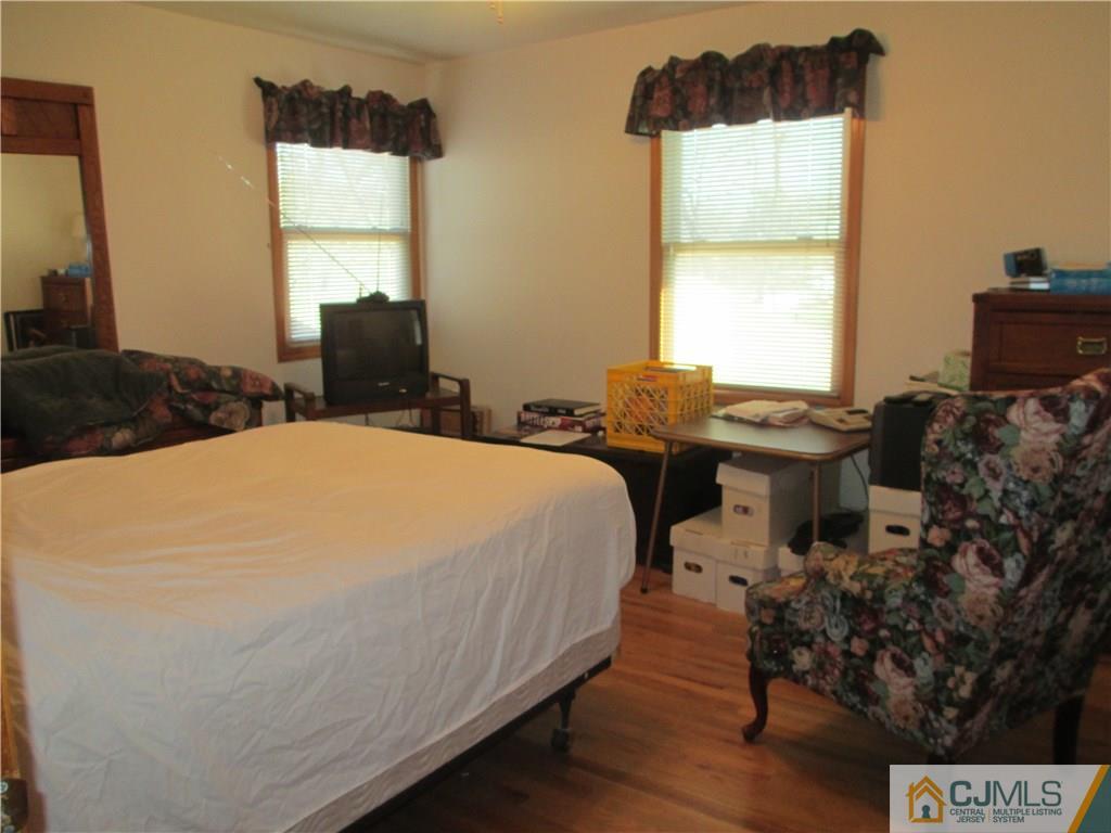 907 New Dover Road Edison, NJ 08820 - Photo 14 of 21 a bed sitting in a bedroom next to a window
