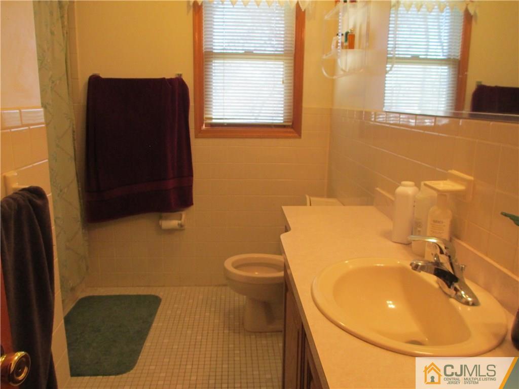 907 New Dover Road Edison, NJ 08820 - Photo 18 of 21 a bathroom with a sink and a mirror
