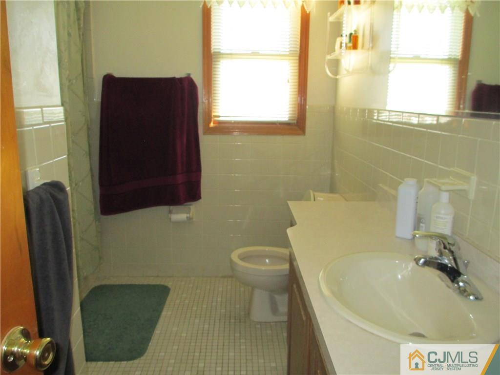 907 New Dover Road Edison, NJ 08820 - Photo 19 of 21 a bathroom with a sink and a toilet