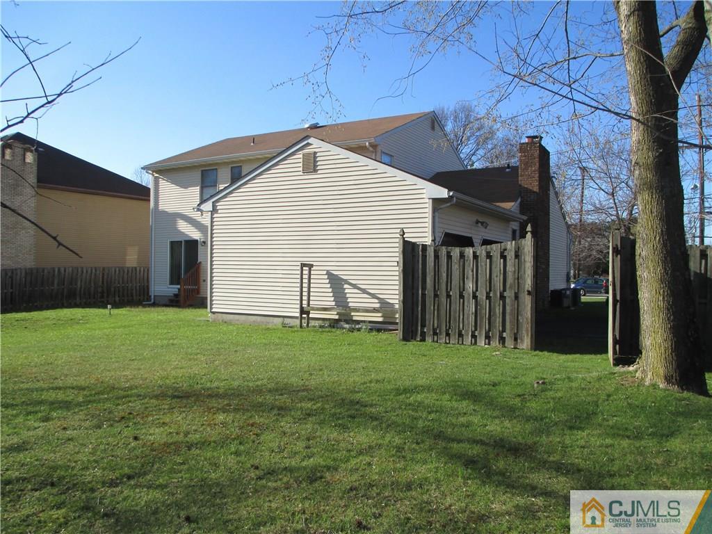 907 New Dover Road Edison, NJ 08820 - Photo 3 of 21 a view of a backyard with potted plants and large tree