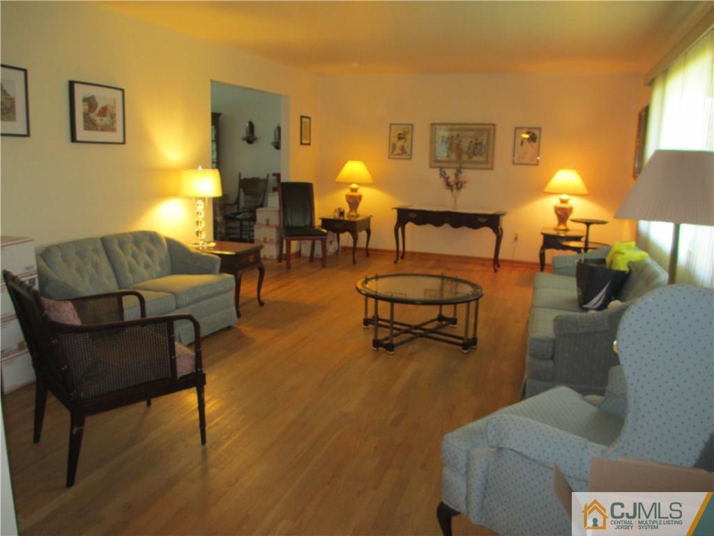 907 New Dover Road Edison, NJ 08820 - Photo 6 of 21 a living room with furniture and a lamp