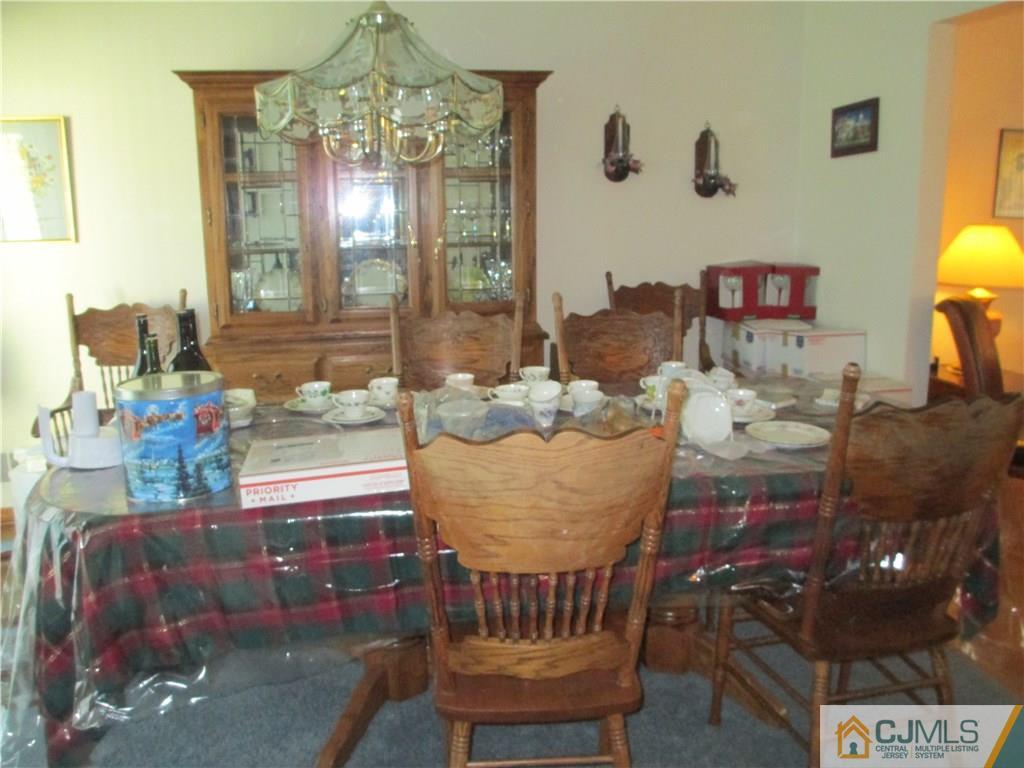 907 New Dover Road Edison, NJ 08820 - Photo 8 of 21 a living room with furniture and a chandelier