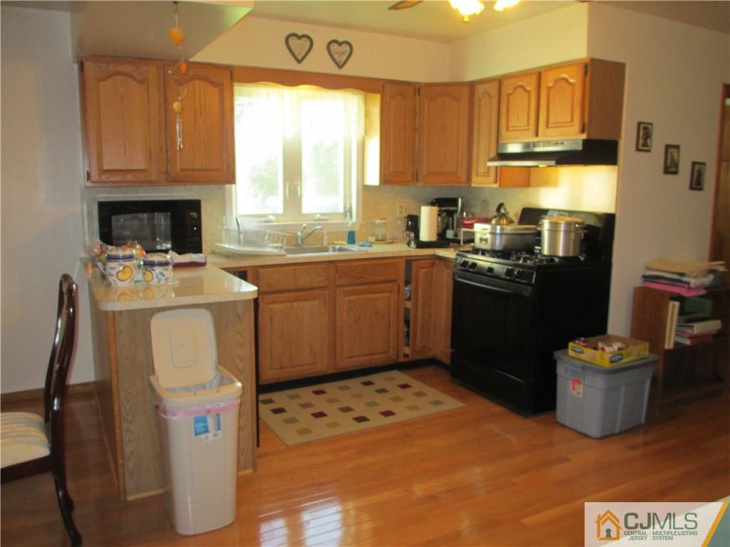 907 New Dover Road Edison, NJ 08820 - Photo 9 of 21 a kitchen with a sink cabinets and window