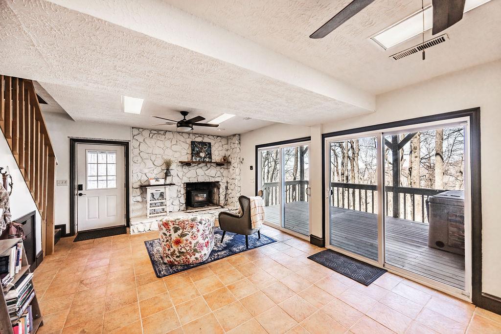 1006 Chestnut Cove Trail Jasper, GA 30143 - Photo 14 of 33 a living room with furniture large window and a fireplace