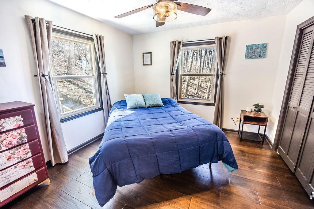 1006 Chestnut Cove Trail Jasper, GA 30143 - Photo 18 of 33 a bed sitting in a bedroom next to a window