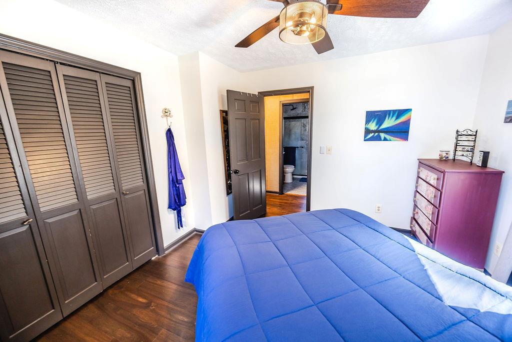 1006 Chestnut Cove Trail Jasper, GA 30143 - Photo 19 of 33 a bedroom with a bed and wooden floor