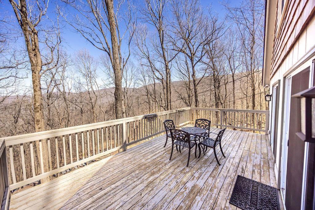 1006 Chestnut Cove Trail Jasper, GA 30143 - Photo 26 of 33 a view of a table and chairs on the roof deck